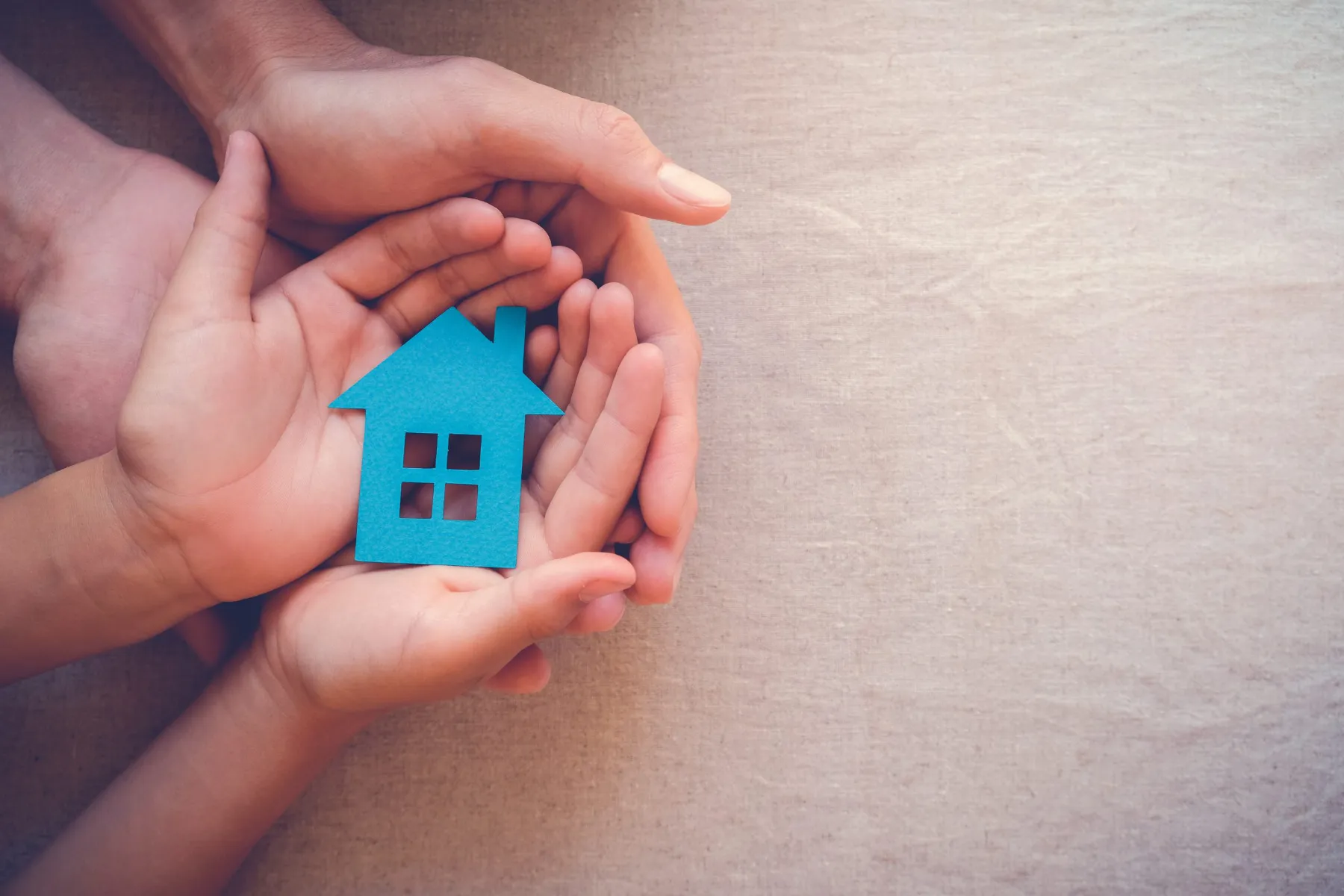 Many hands holding house symbol